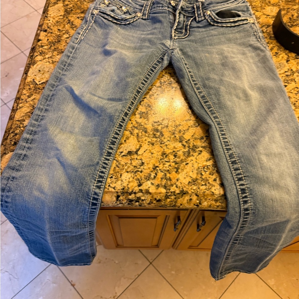 Blue Boot Cut Jeans with Distressed Details